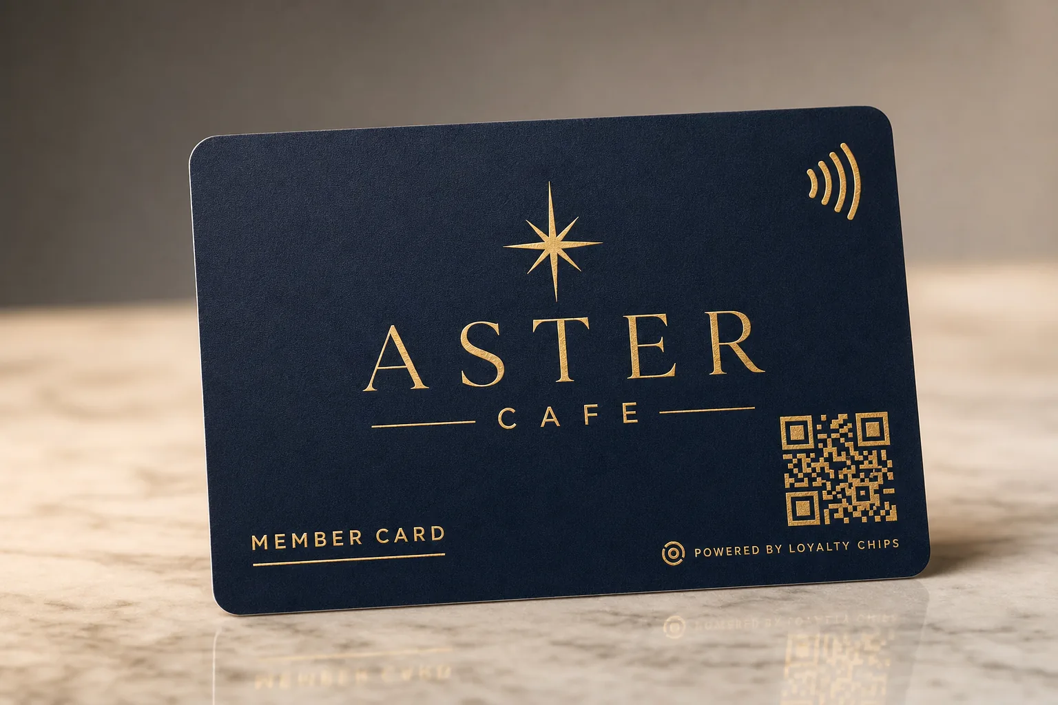 A branded LoyaltyChips member card with NFC and QR photographed on warm marble